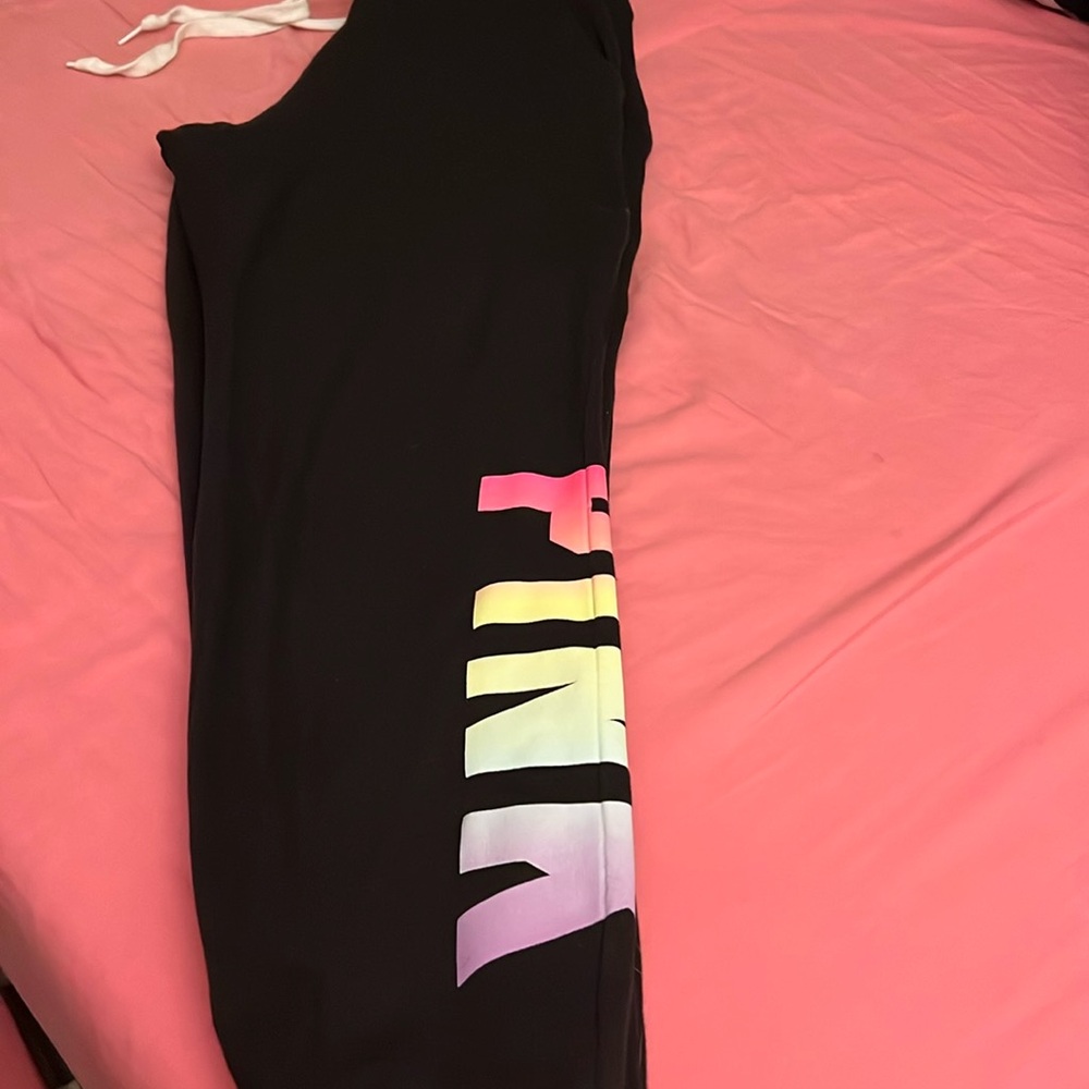 Pink size medium in hoodie and small in joggers black with rainbow lettering